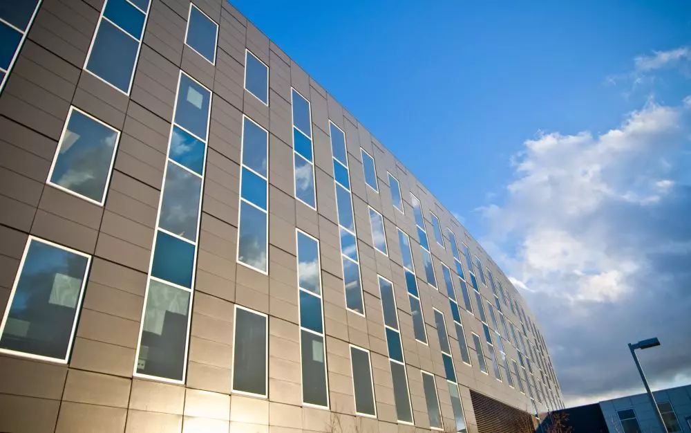 View of the sky reflecting in the windows of the building