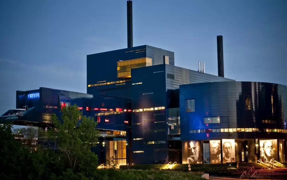 Illuminated theater building at dusk