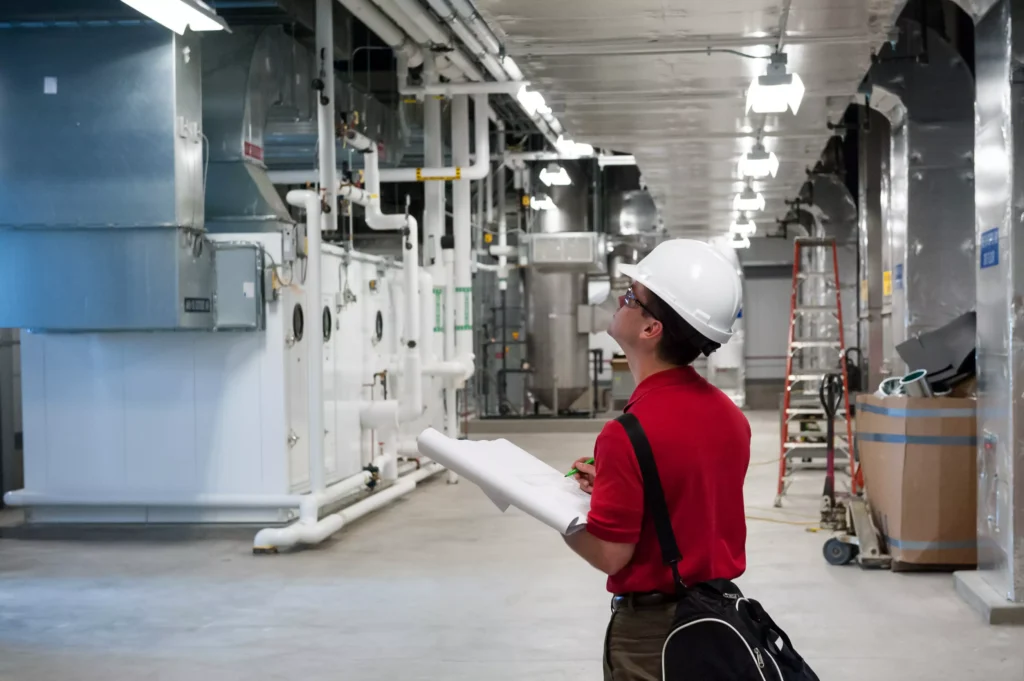 Engineer checking machine compliance with papers